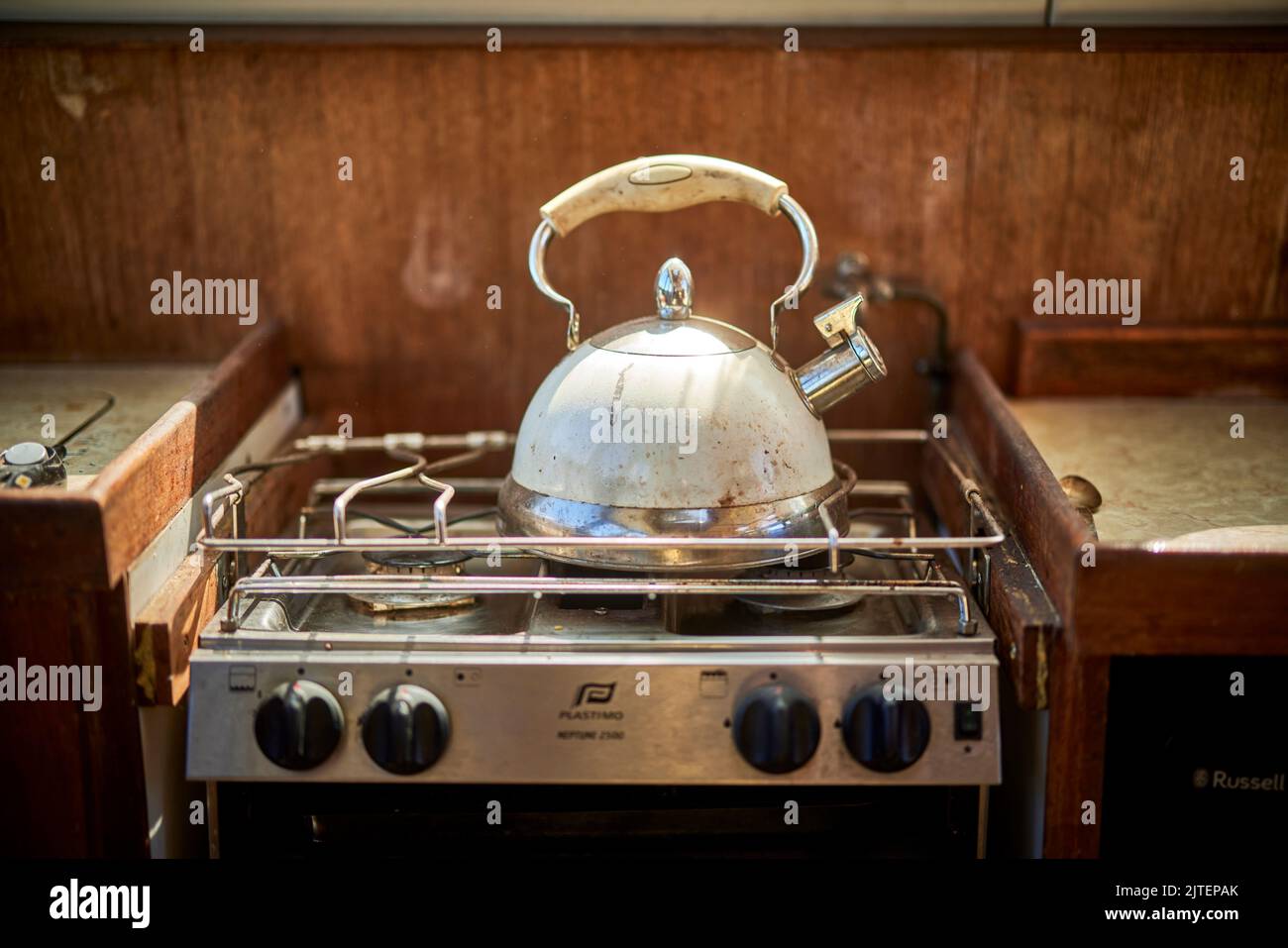 Small kitchen stove and kettle on a boat Stock Photo