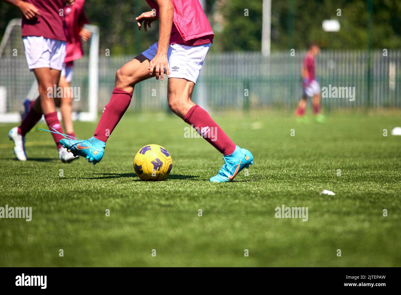 Young footballer in control of the ball on a Astra Turf pitch Stock Photo -  Alamy