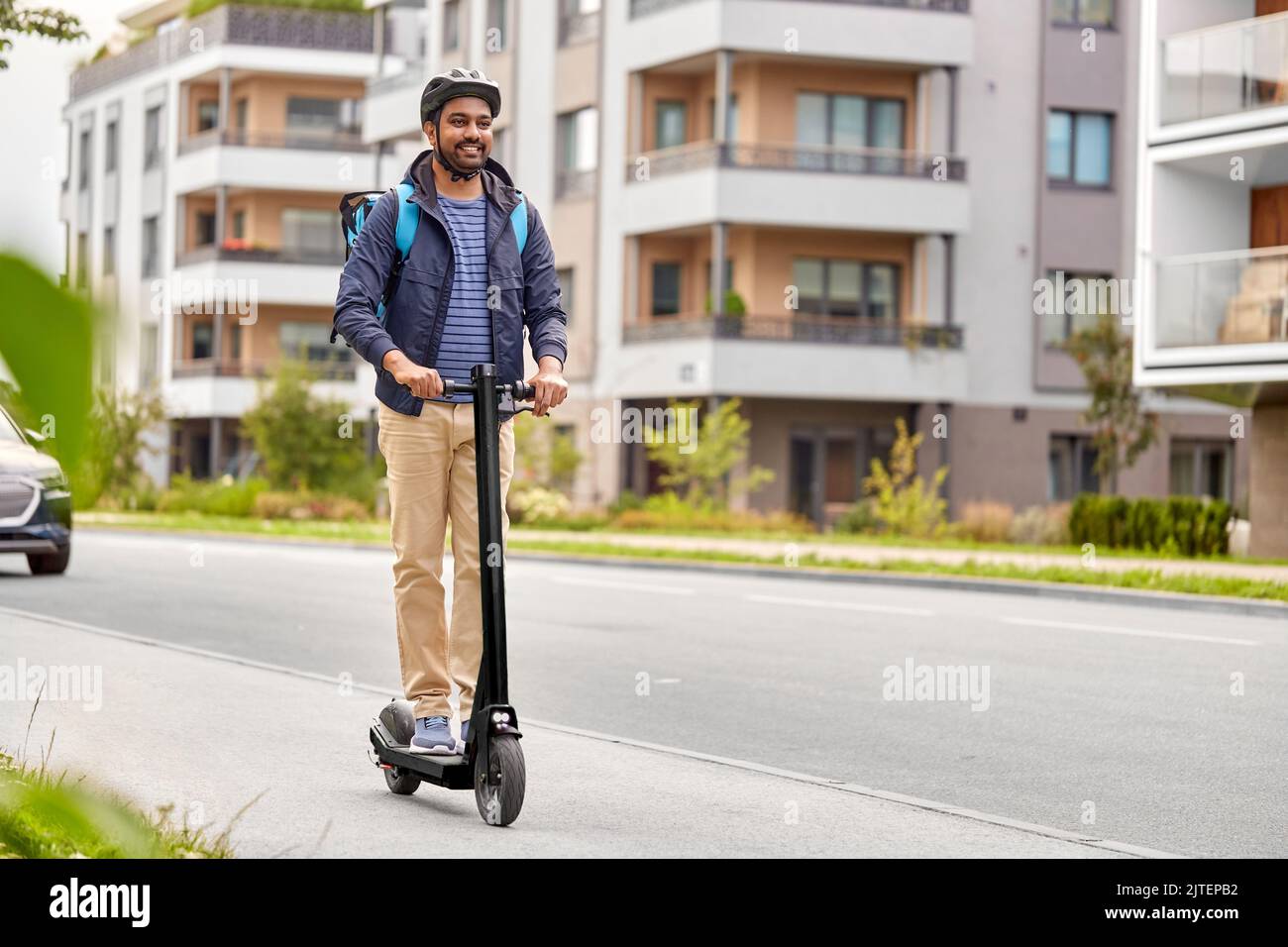 food delivery man with bag riding scooter Stock Photo Alamy