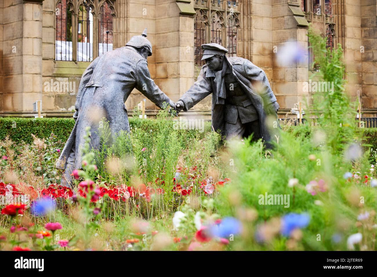 “All together now” statue by Andy Edwards, World War 1 Christmas truce soldiers played football. St Luke's 'Bombed Out' Church, Liverpool, UK Stock Photo