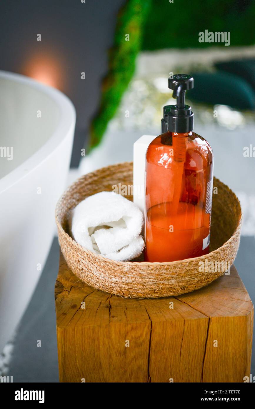 Soap and shampoo dispensers on a shelf inside a shower box bathroom