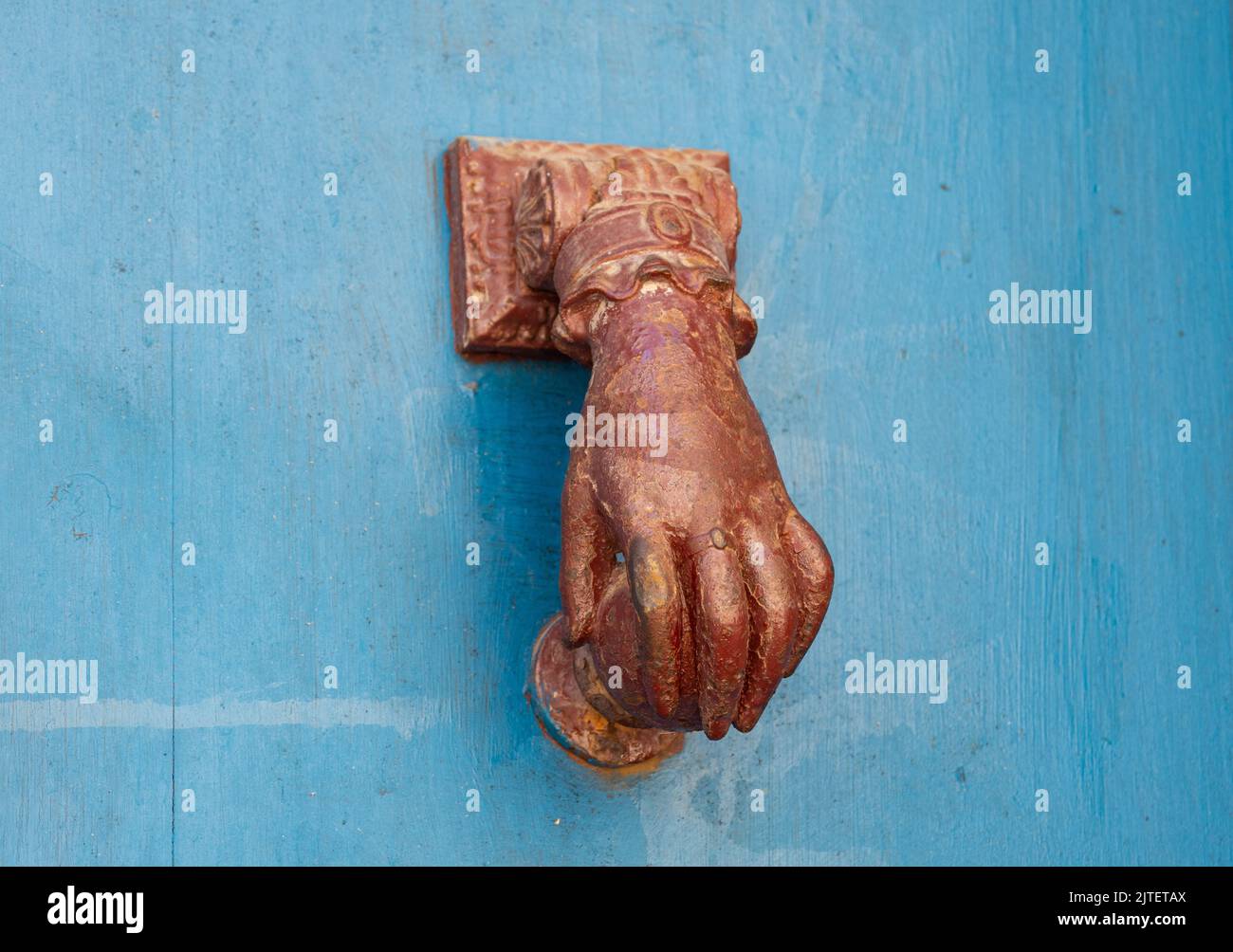 Hand shaped door knocker Stock Photo
