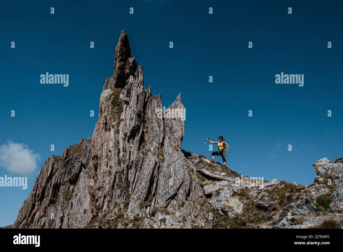 Woman passing through rock peaks. Mountaineering on Pizzo Centrale, Switzerland, Europe Stock Photo