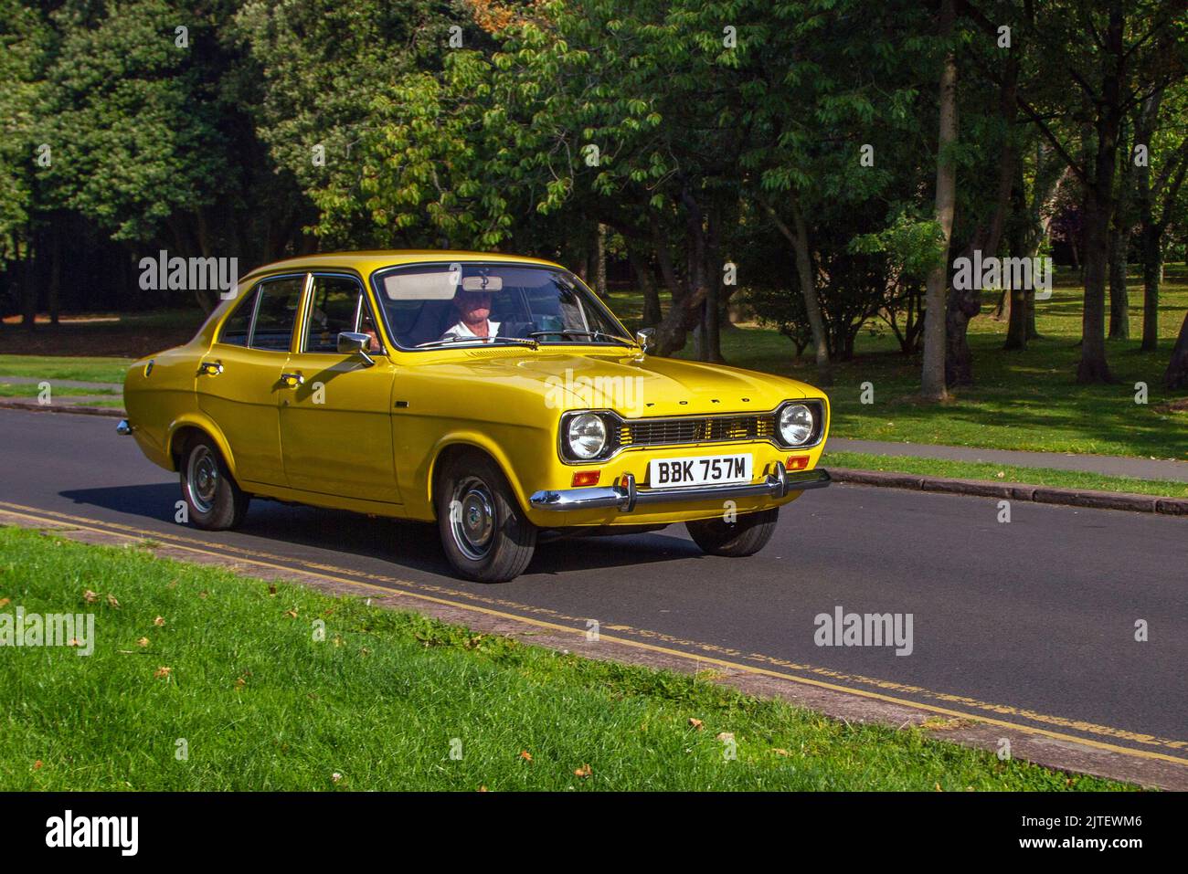 1973 70s seventies Yellow FORD 1098cc petrol; Cars arriving at the annual Stanley Park Classic Car Show. Stanley Park Classics Yesteryear Motor Show is hosted by Blackpool Vintage Vehicle Preservation Group, UK. Stock Photo