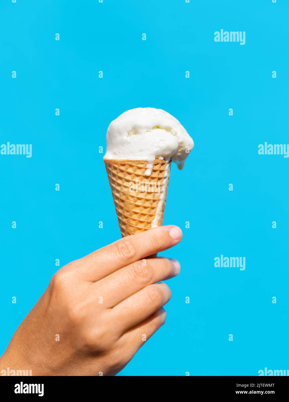 close up of hand holding waffle ice cream cone Stock Photo