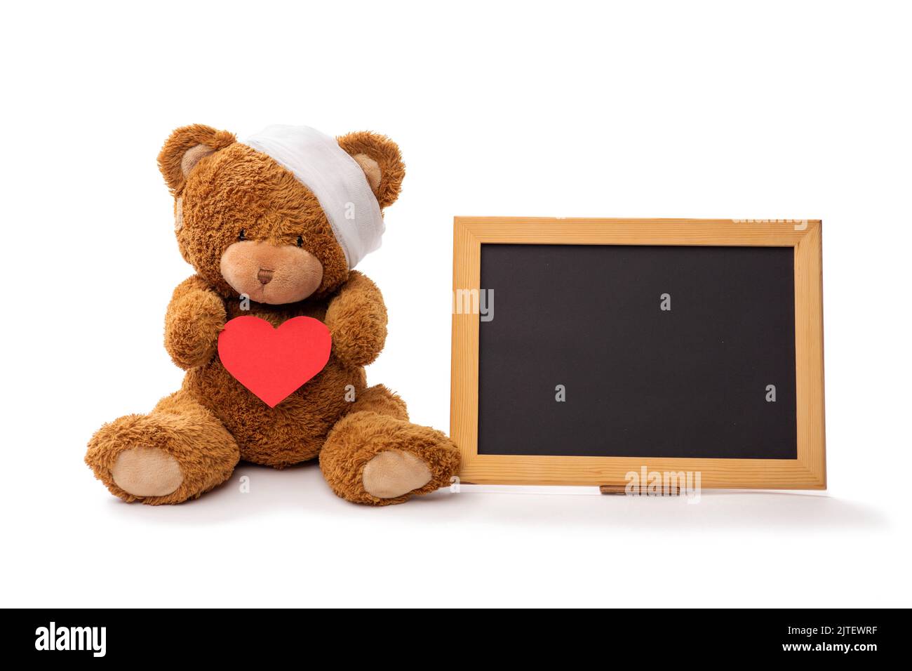 teddy bear toy with bandaged head and red heart Stock Photo - Alamy