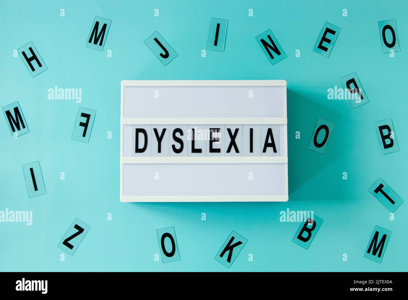 White lightbox with DYSLEXIA word and different letters haphazardly