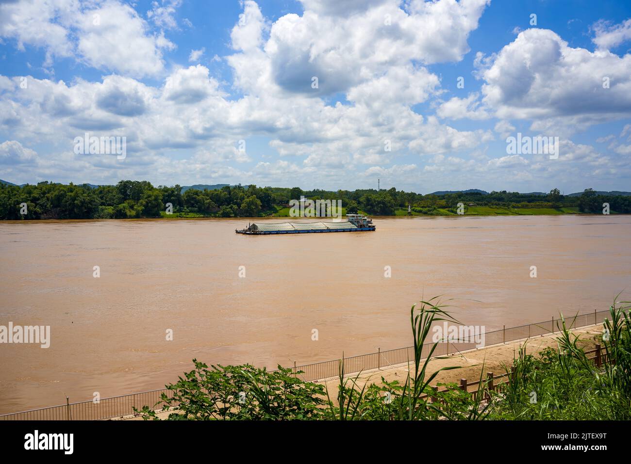 Large sand mining boat driving on the river outdoors Stock Photo