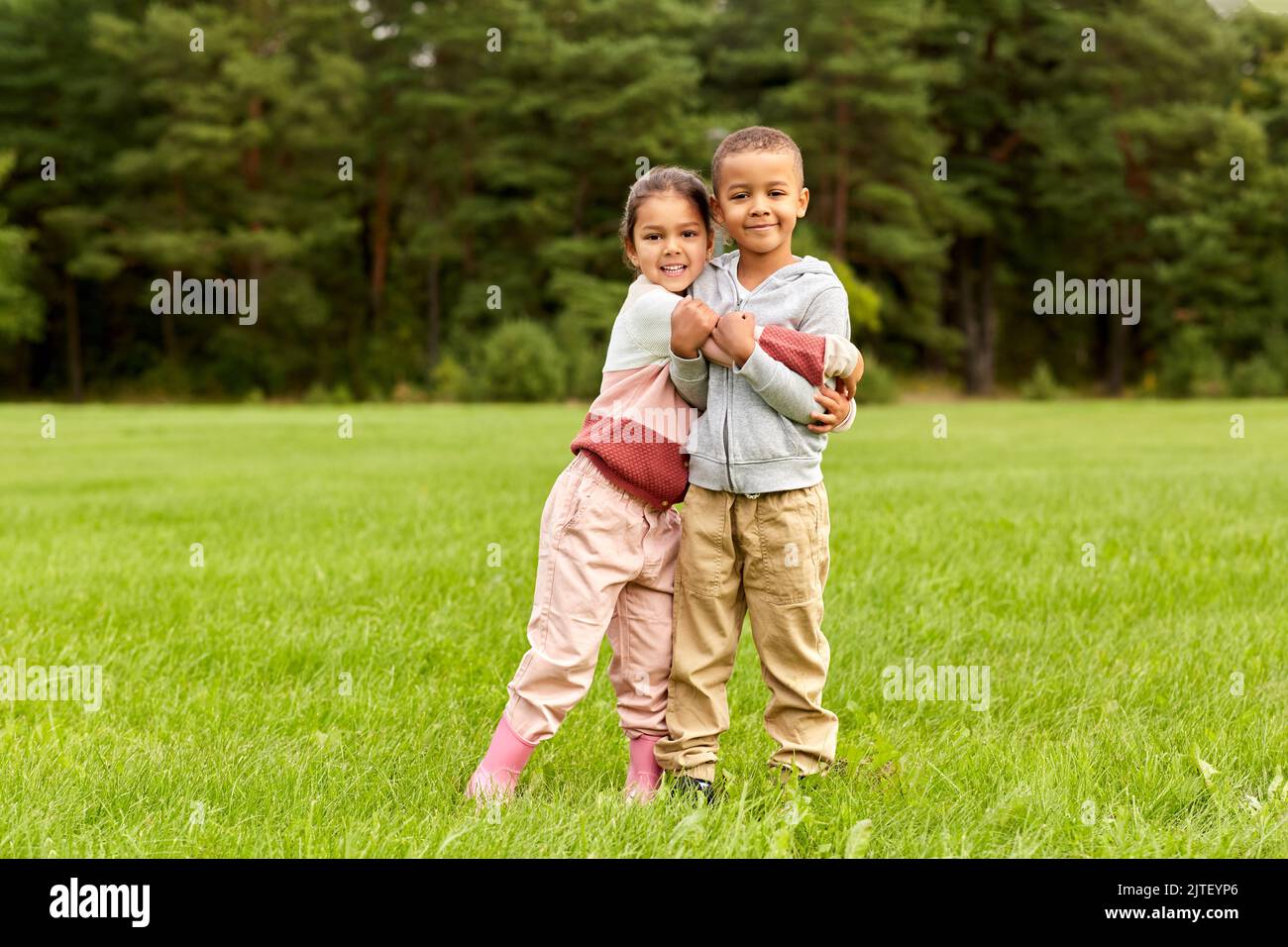 happy little boy and girl hugging at park Stock Photo - Alamy