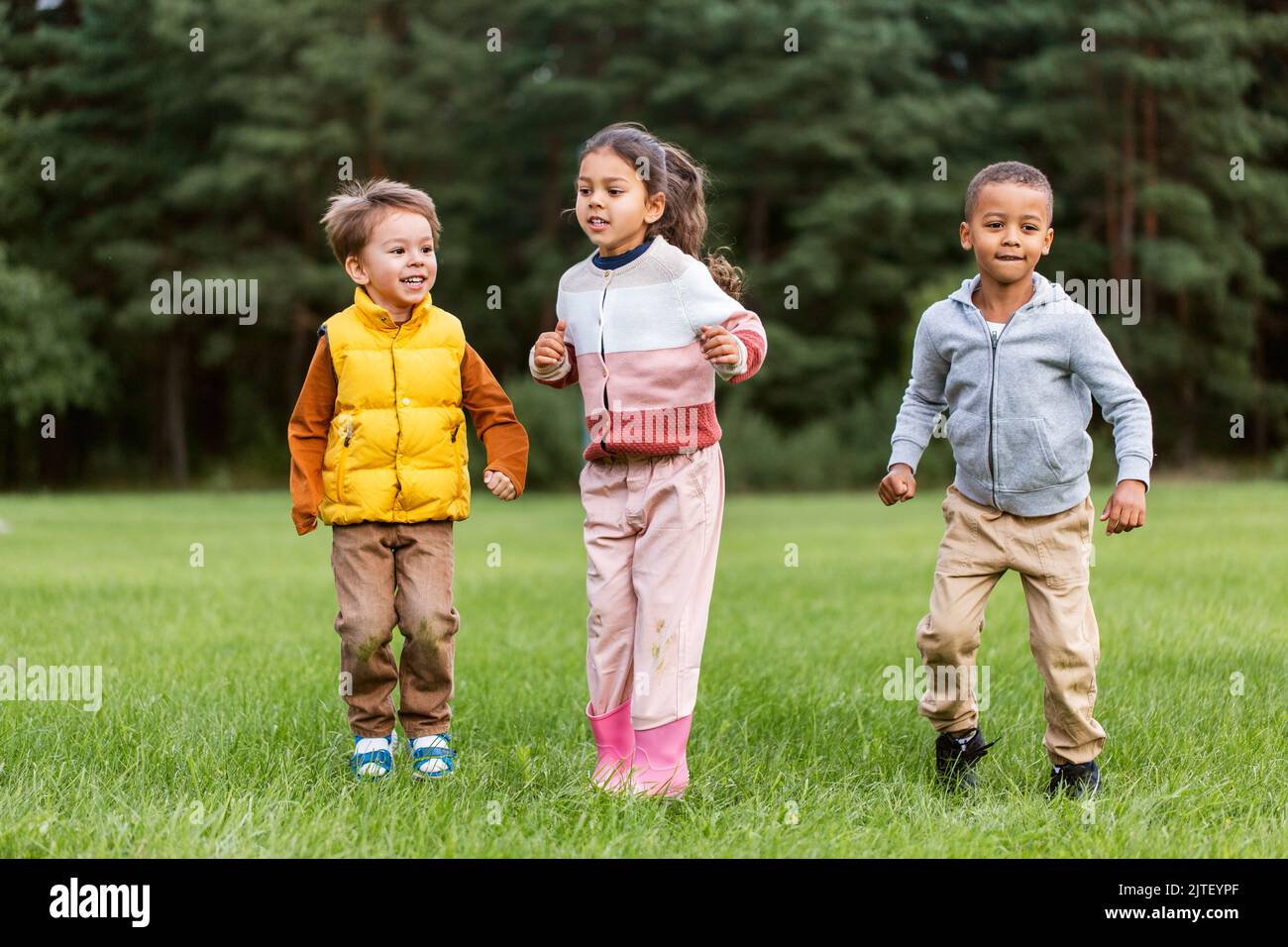 happy children playing and jumping at park Stock Photo - Alamy