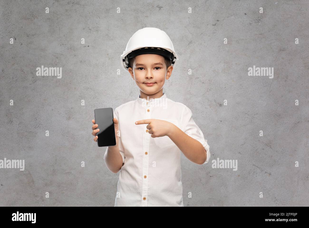 little boy in construction helmet with smartphone Stock Photo Alamy