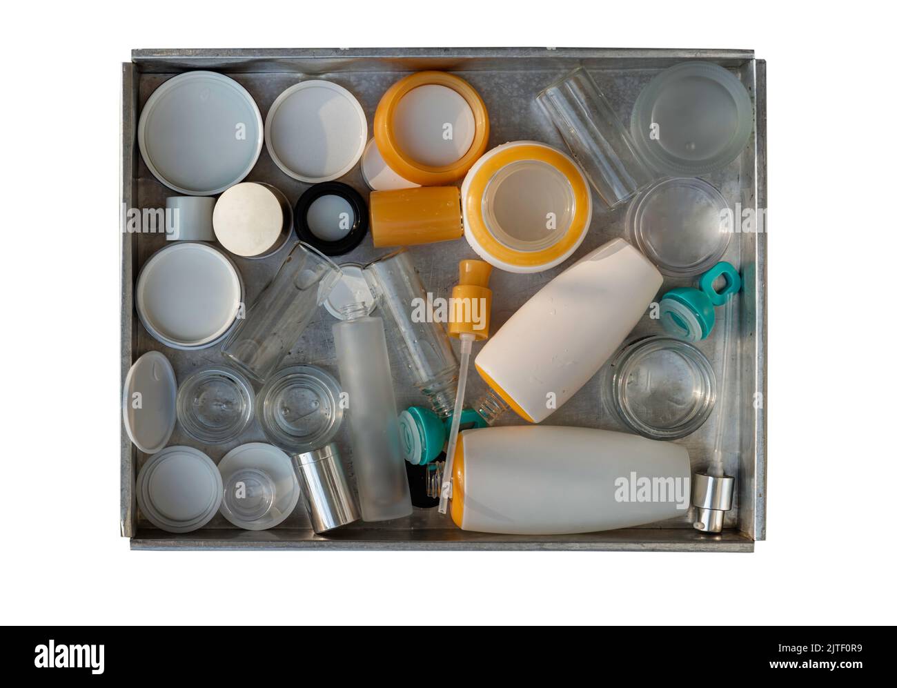 Used glass and plastic cosmetic container jars ready to recycle in