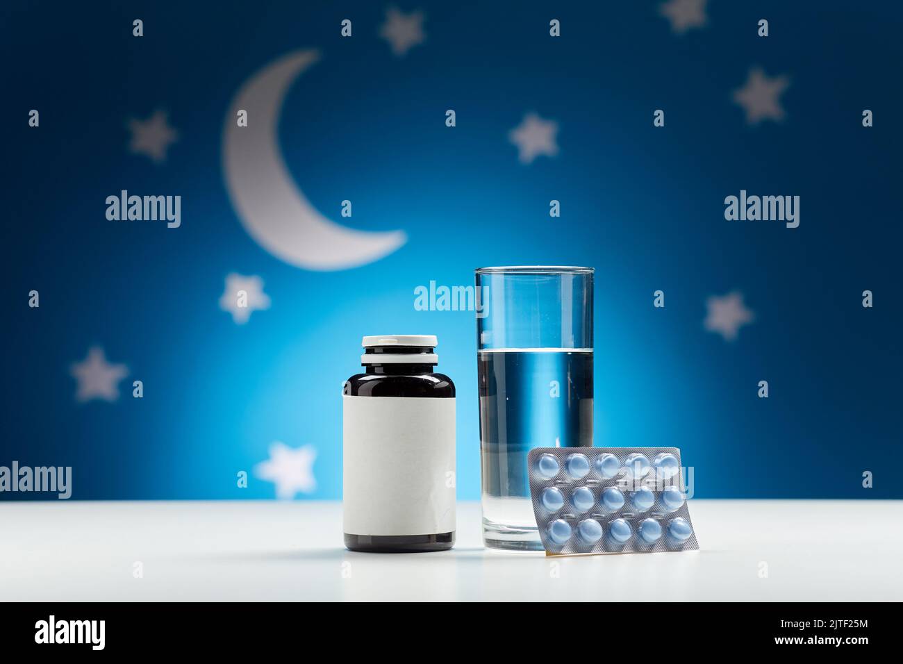 glass of water and sleeping pills at night Stock Photo