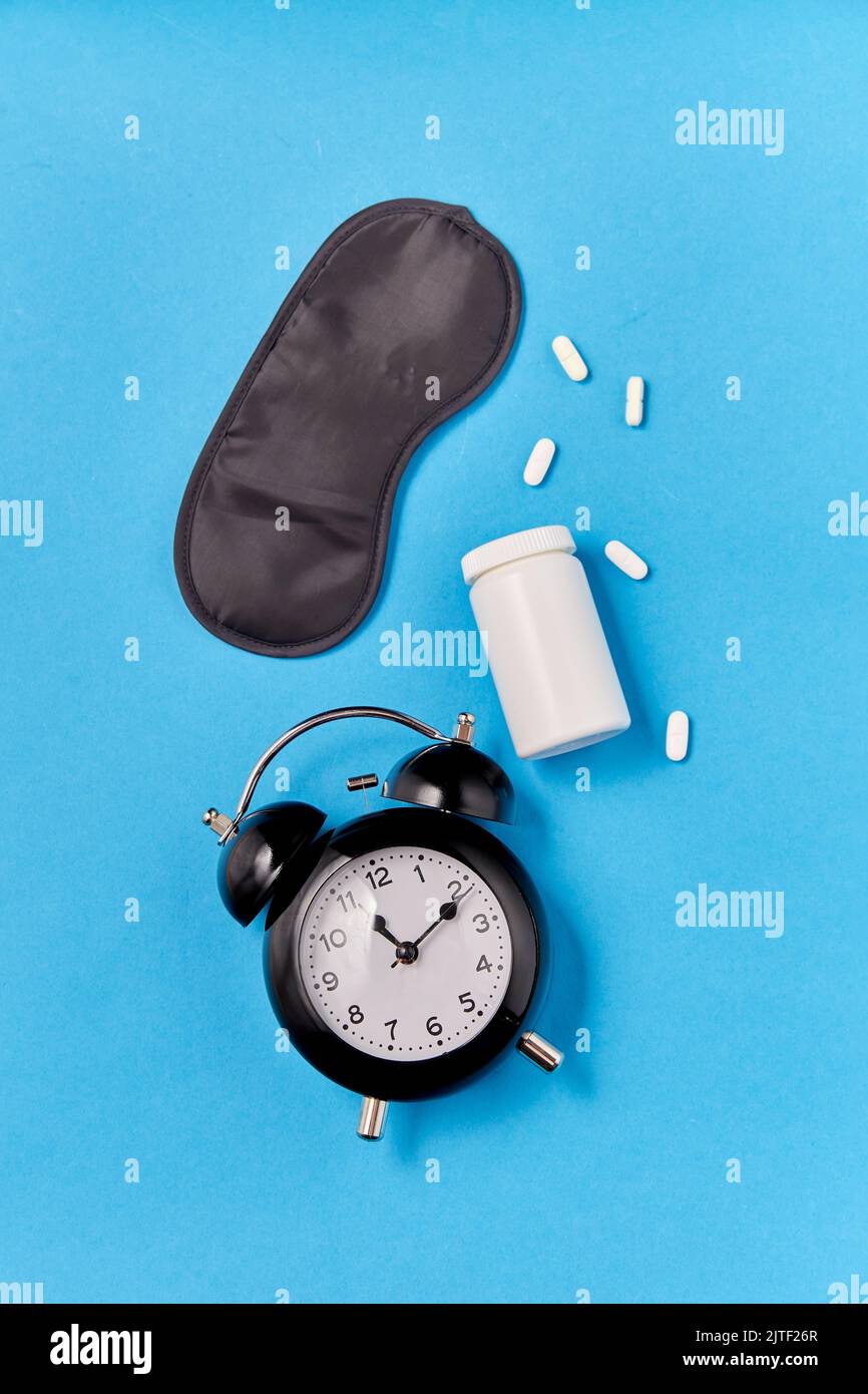 alarm clock, eye sleeping mask and pills Stock Photo Alamy