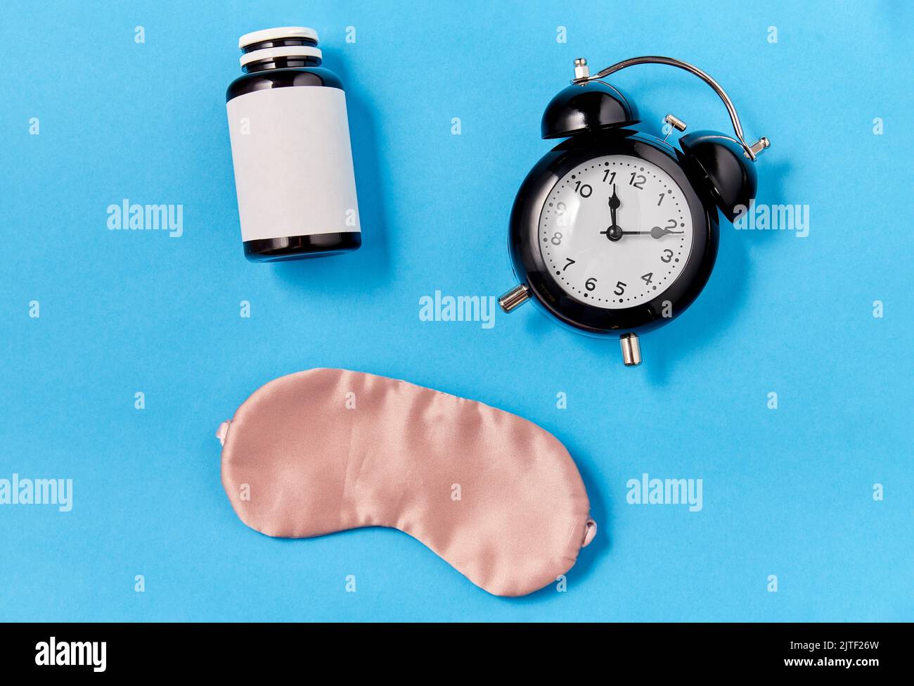 alarm clock, eye sleeping mask and pills Stock Photo Alamy