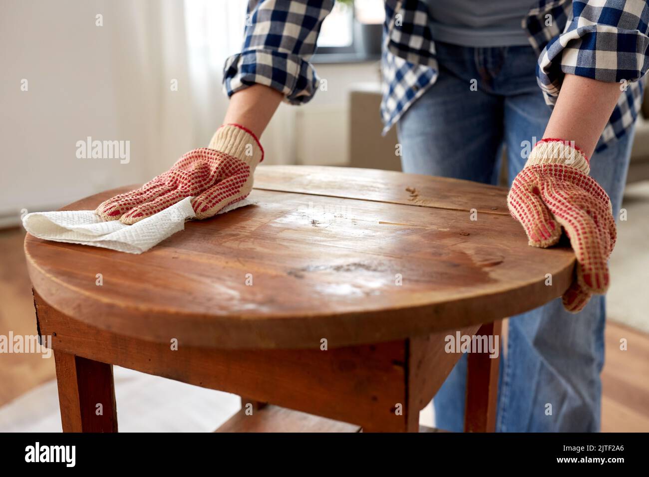 woman cleaning old table surface with paper tissue Stock Photo Alamy