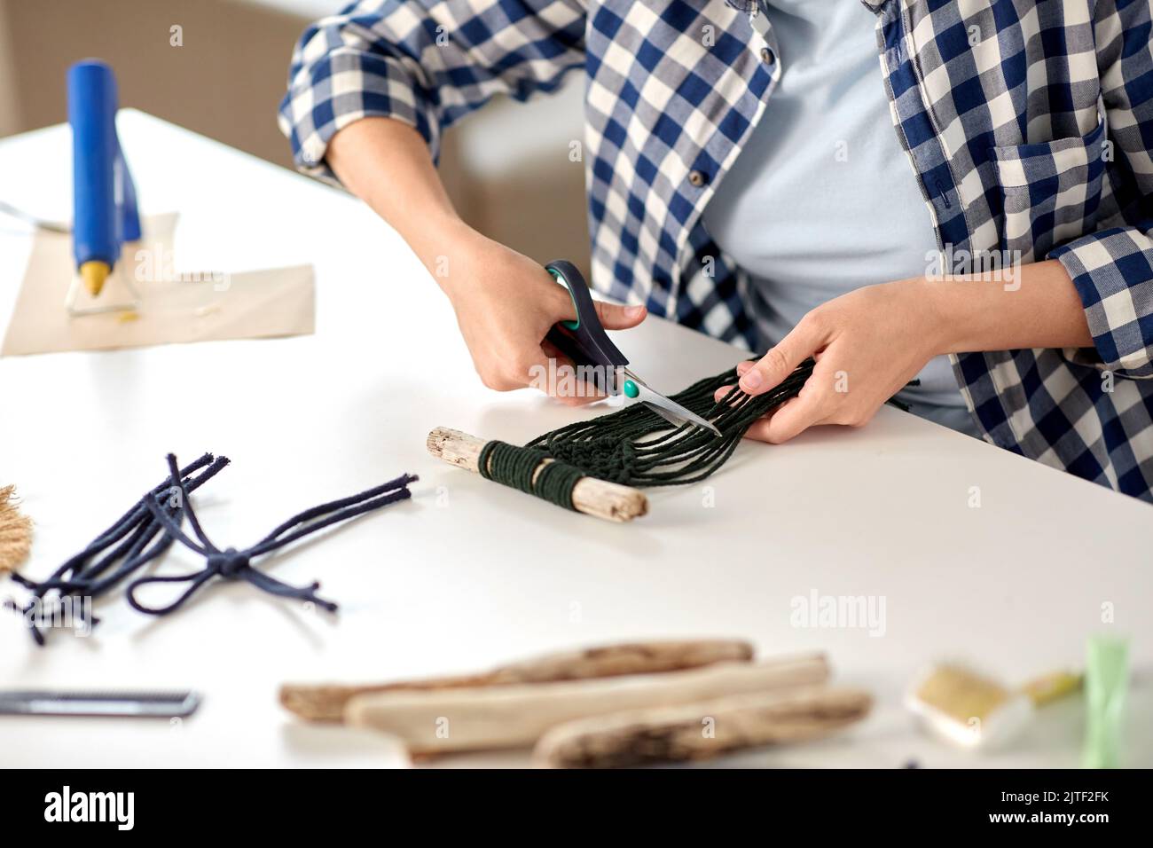woman cutting macrame cords with scissors Stock Photo Alamy