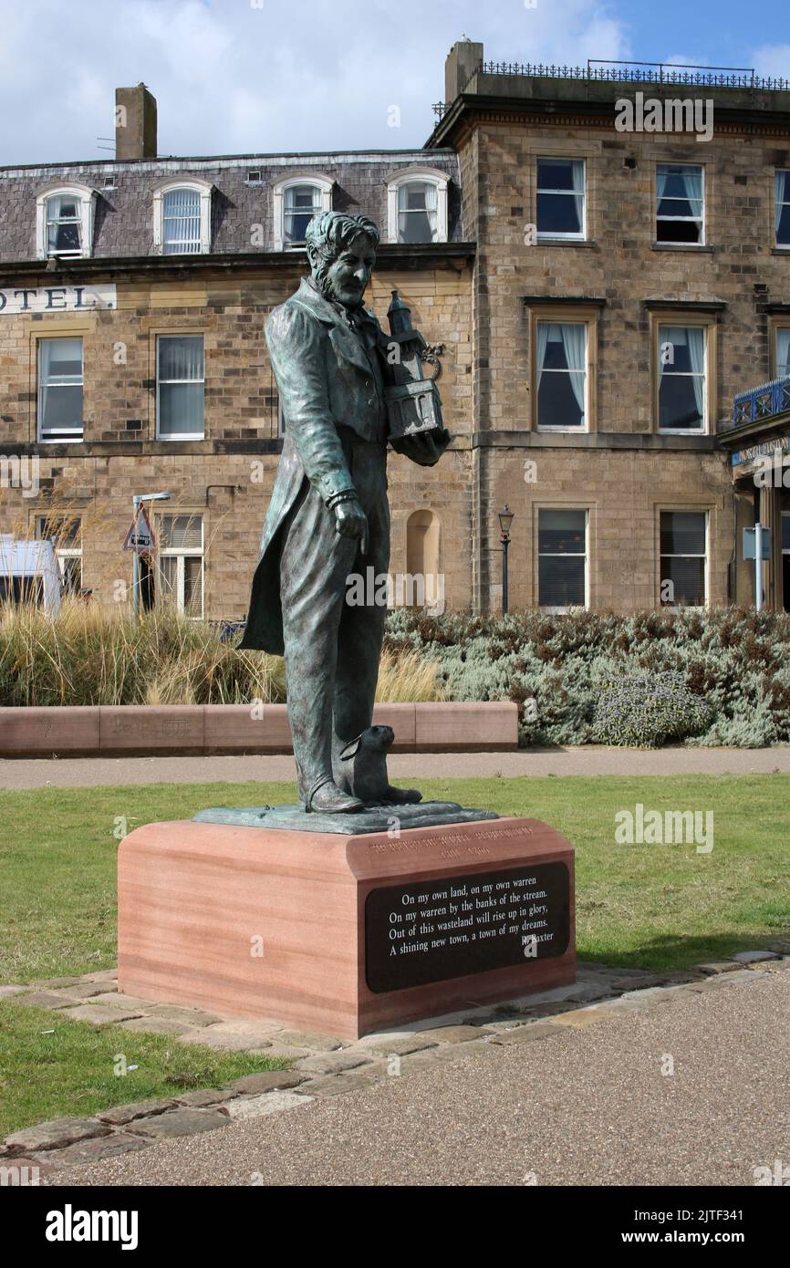 View of the Sir Peter Hesketh Fleetwood bronze statue in Euston Gardens, Fleetwood, Lancashire with the famous North Euston Hotel in the background. Stock Photo
