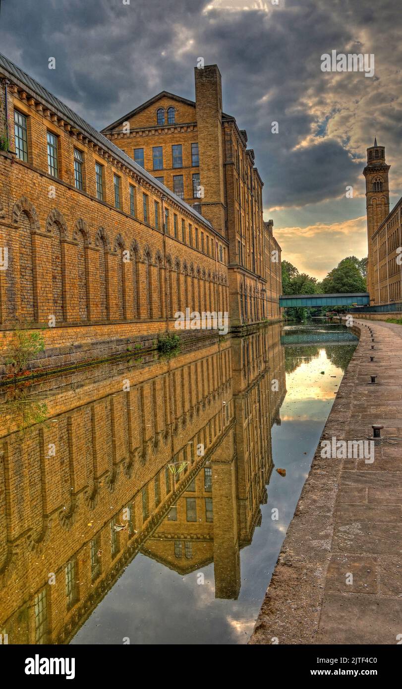 Salts Mill, textile factory, by Leeds and Liverpool Canal, with reflection,Saltaire,Shipley,Bradford,West Yorkshire,England,UK,BD18 3HU Stock Photo