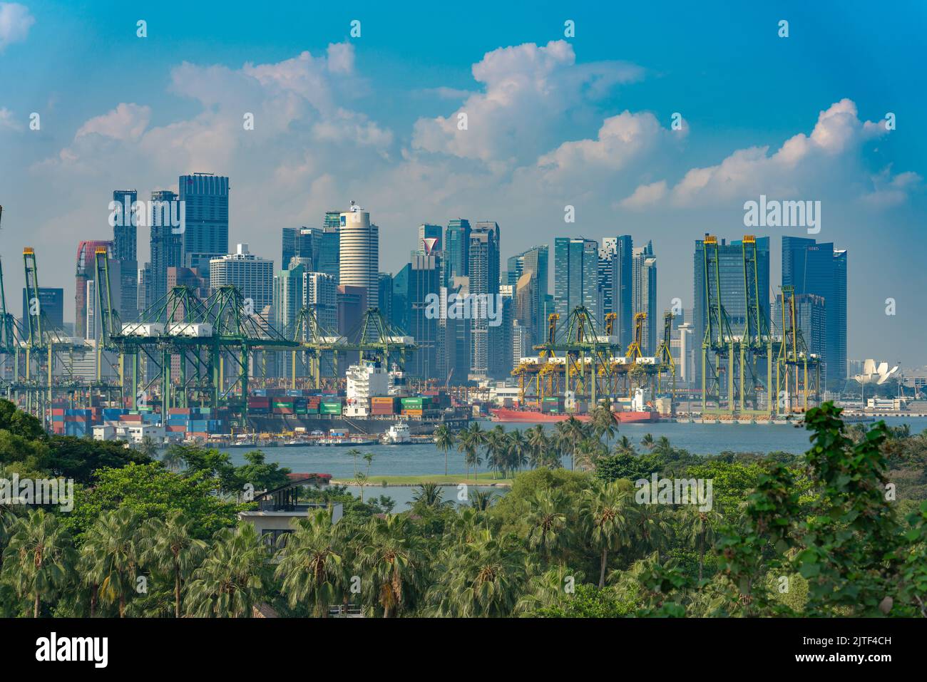 Singapore - 2 Oct, 2018: View towards the container harbour with palm trees in the foreground. Stock Photo