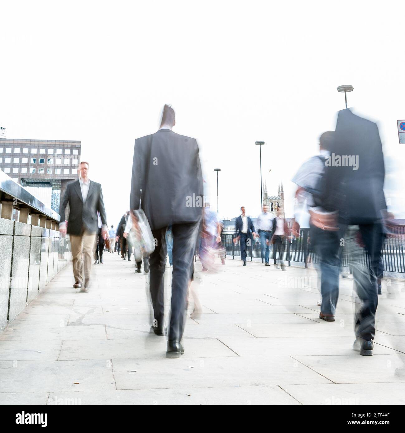 London Commuters. Abstract high-key long exposure blurs of London business and office workers on their way home during the morning rush hour. Stock Photo