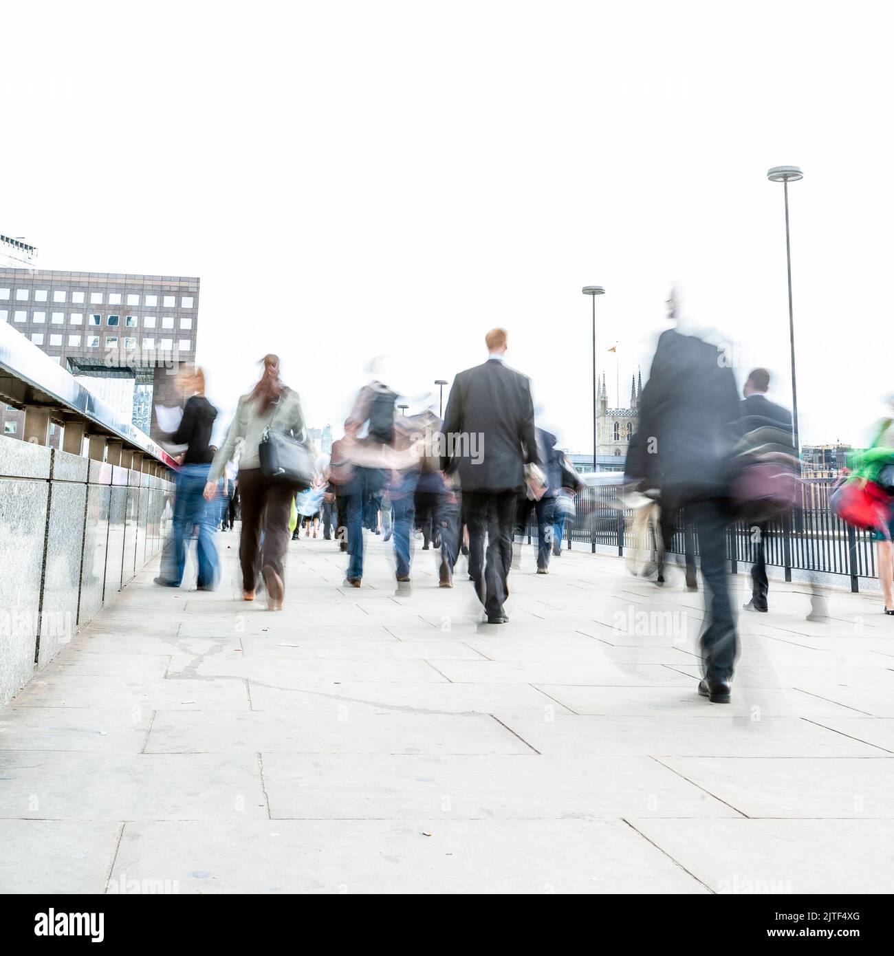 London Commuters. Abstract high-key long exposure blurs of London business and office workers on their way home during the morning rush hour. Stock Photo