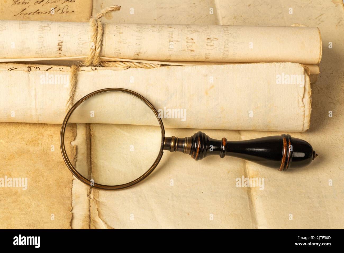 Magnifying glass with old sheets Stock Photo