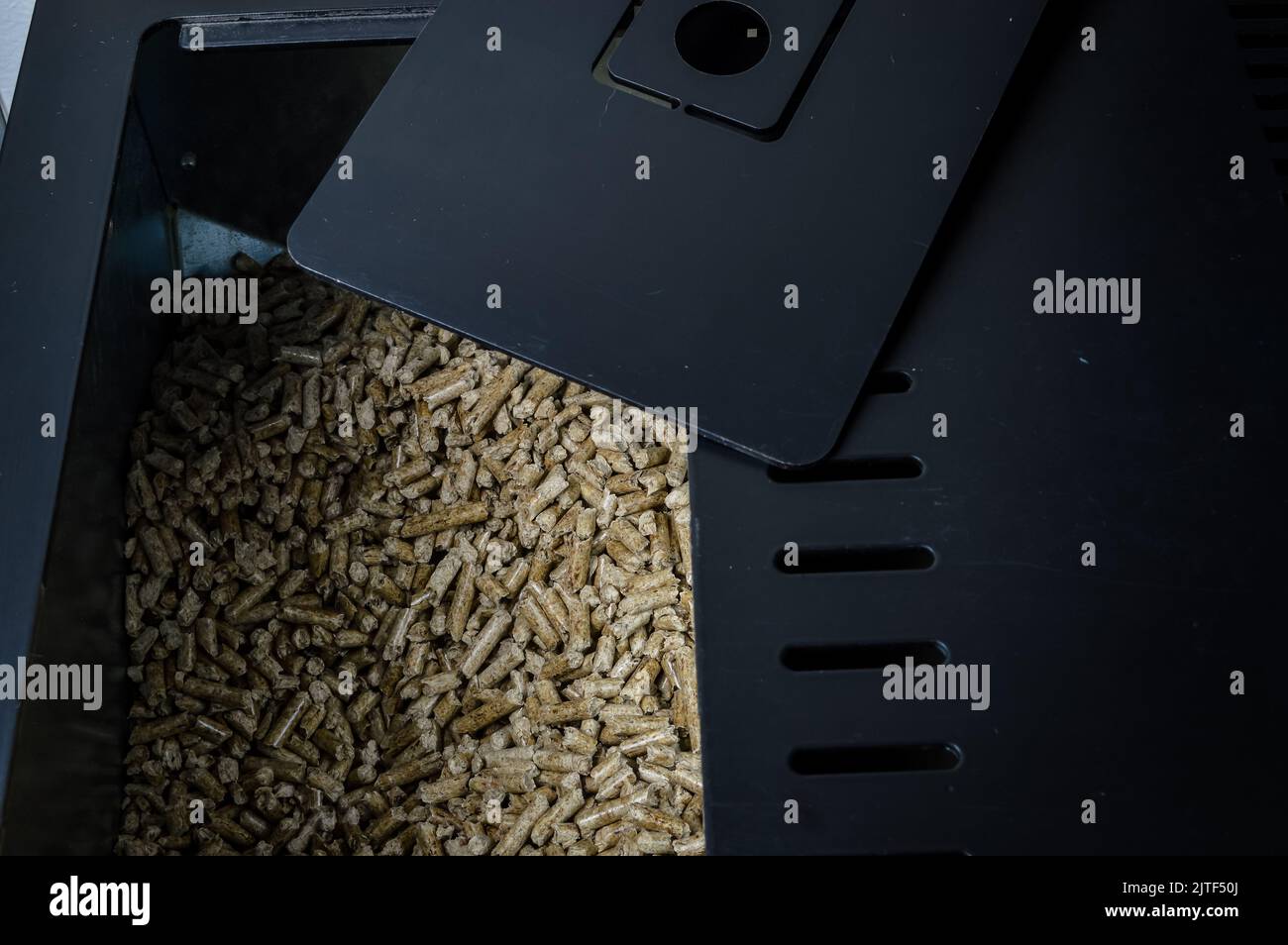 compartment of a stove filled with wood pellets for heating Stock Photo