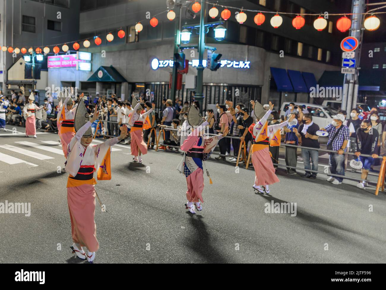 Tokushima, Japan - August 12, 2022: Dancers wearing pink kimonos perform at Japanese street festival Stock Photo