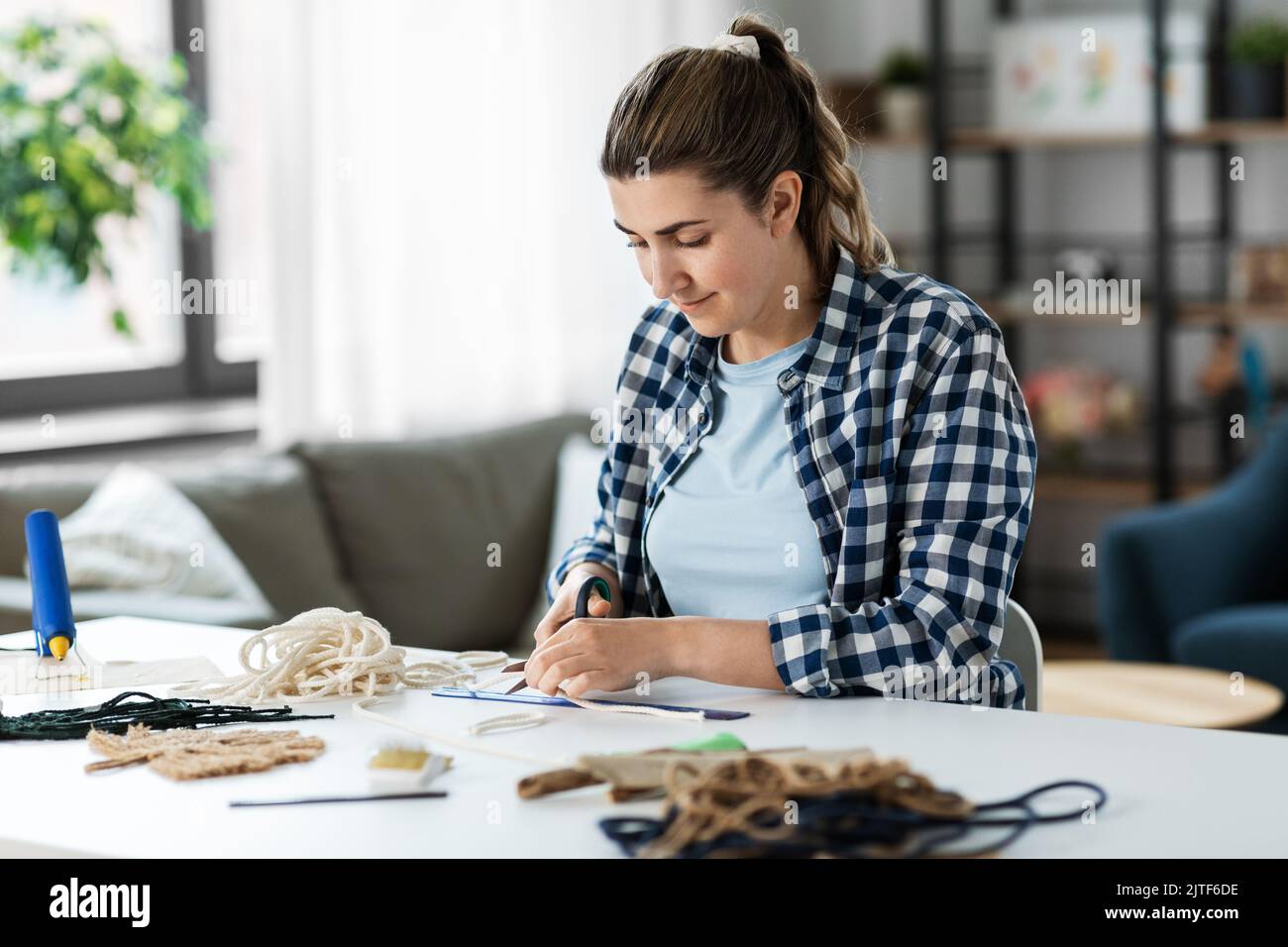 woman cutting macrame cords with scissors Stock Photo Alamy