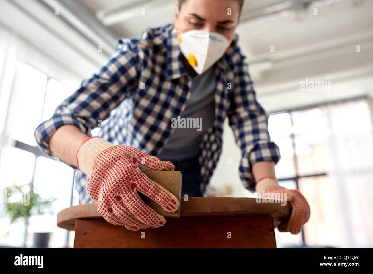 woman in respirator sanding old table with sponge Stock Photo Alamy