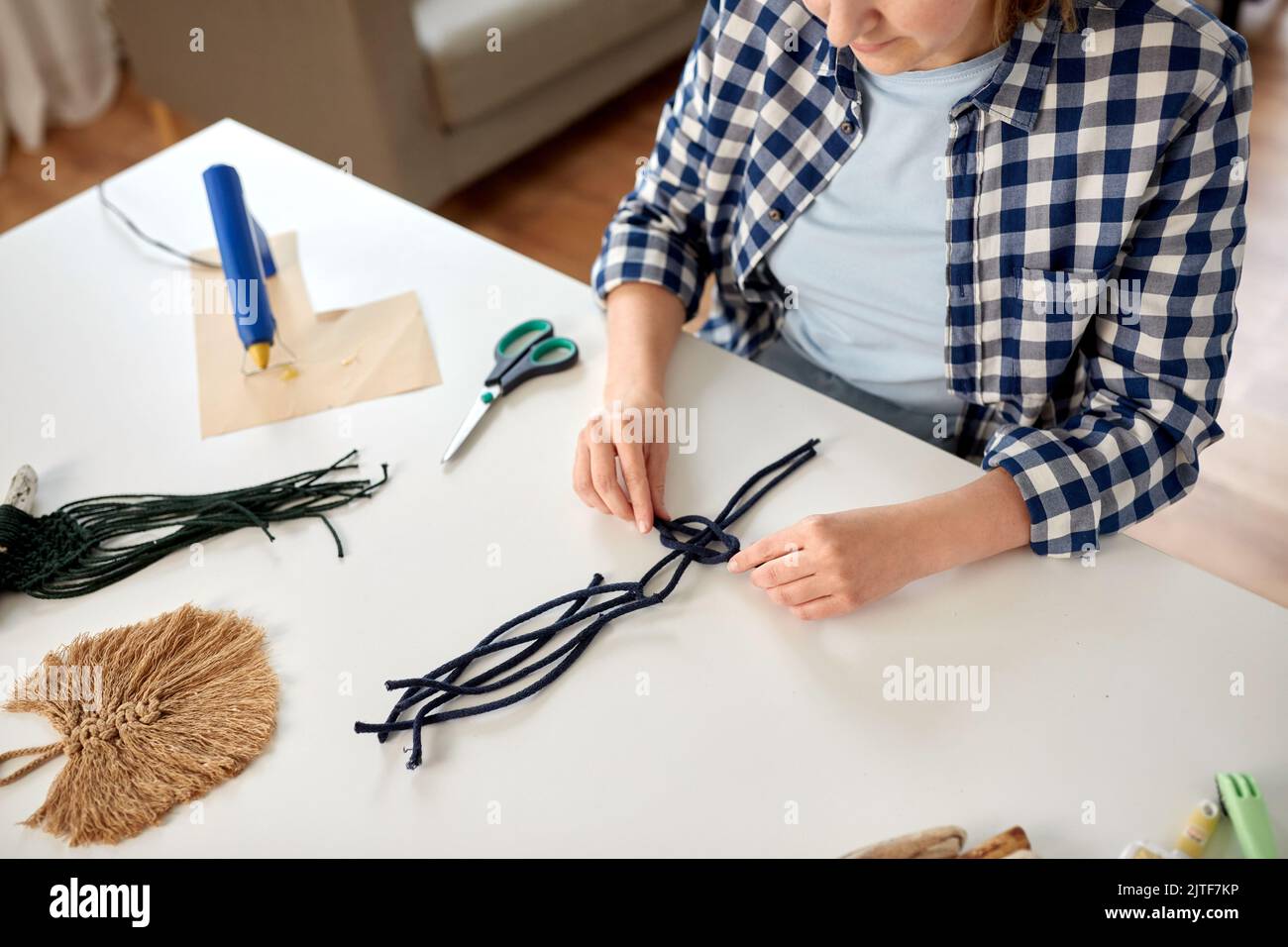 woman making macrame and knotting cords Stock Photo Alamy