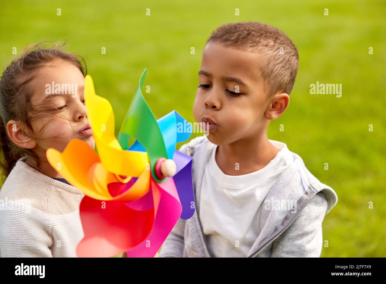 happy children playing with pinwheel at park Stock Photo - Alamy
