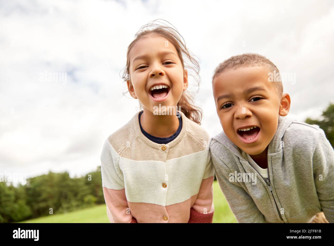 happy little boy and girl at park Stock Photo - Alamy