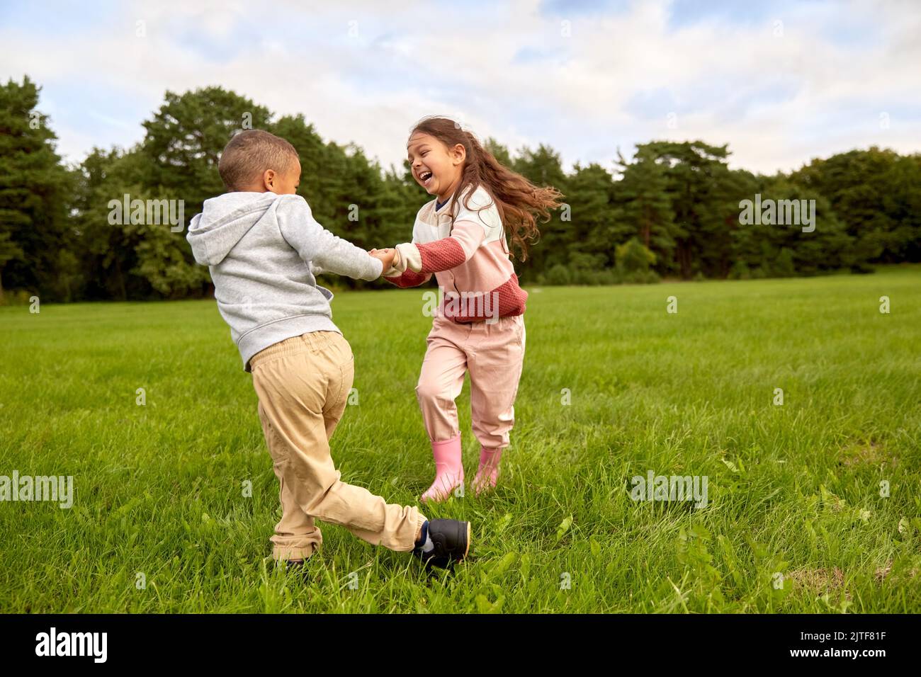 happy little boy and girl having fun at park Stock Photo - Alamy