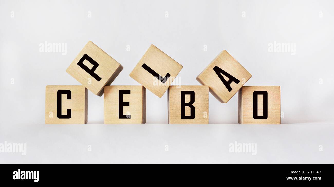 The word PLACEBO written in wooden cubes on a white table Stock Photo