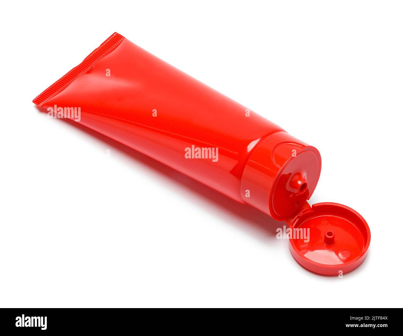 Open Red Plastic Gel Tube Cut Out on White. Stock Photo