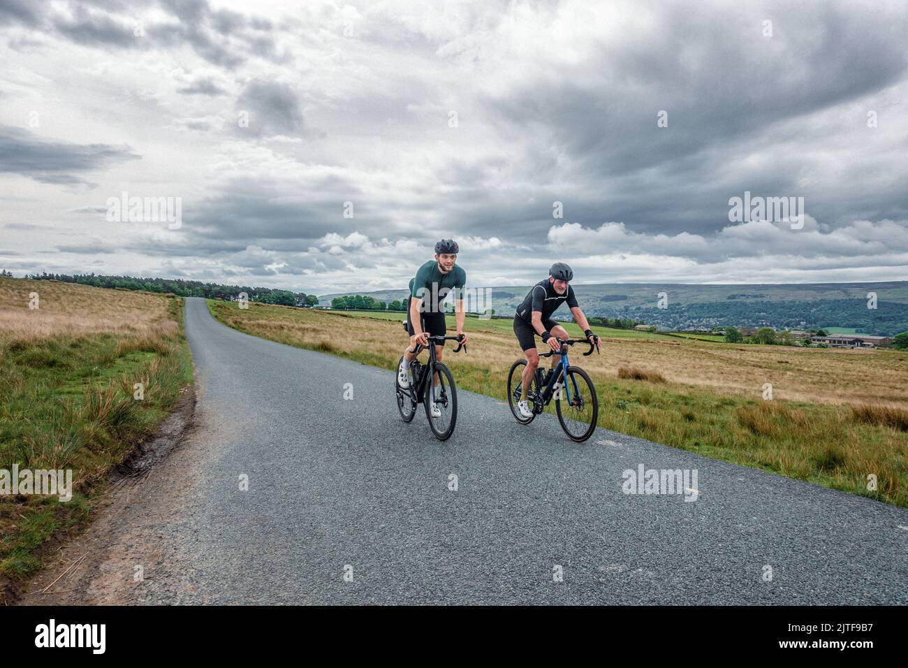 Two men socialising on road bikes, riding over Langbar hill with Ilkley