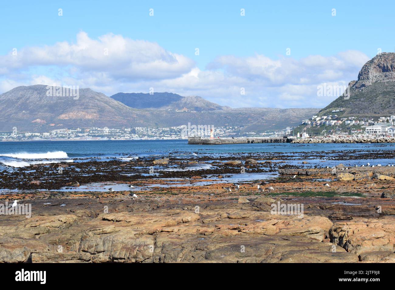 View from Dalebrook Tidal Pool of the ocean and landscape from Kalk Bay to Simon's Town on a mild, clear winters day Stock Photo