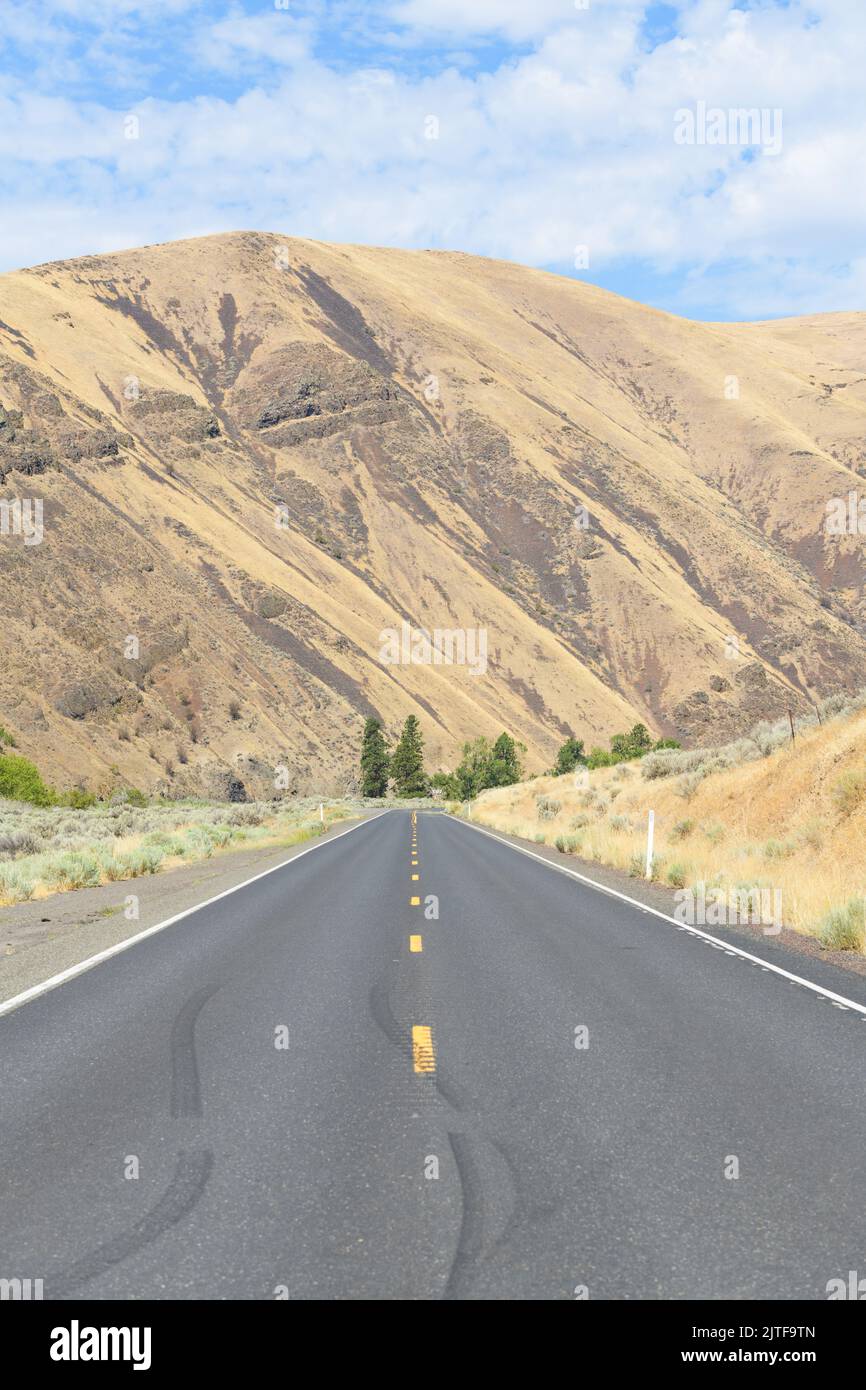 Yakima River Canyon Scenic Byway passes basalt hillsides in Central Washington on an arrid summer day Stock Photo
