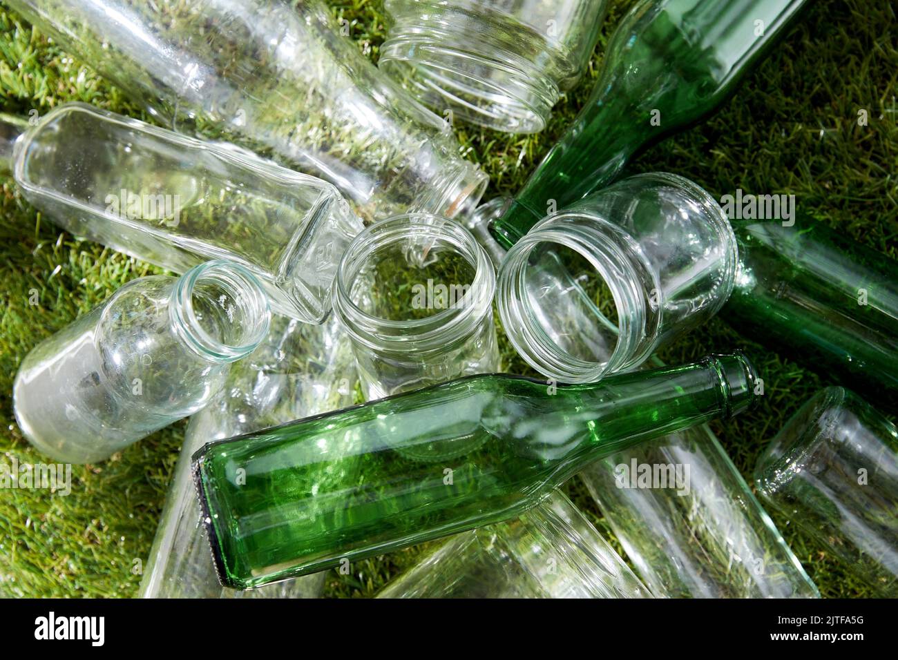close up of empty glass bottles and jars on grass Stock Photo