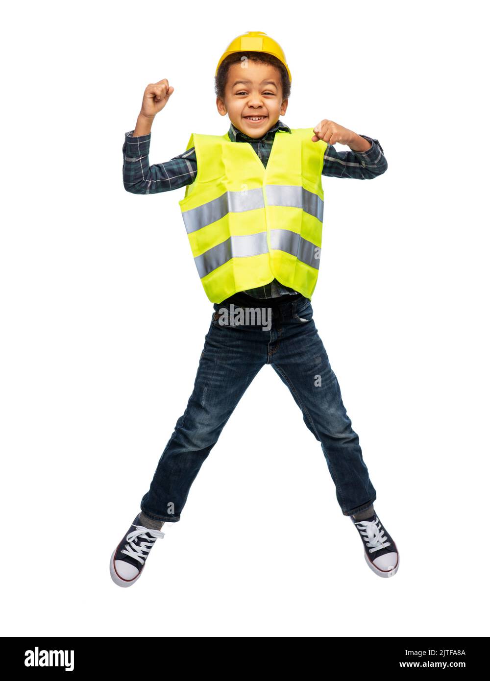 boy in safety vest and construction helmet jumping Stock Photo Alamy