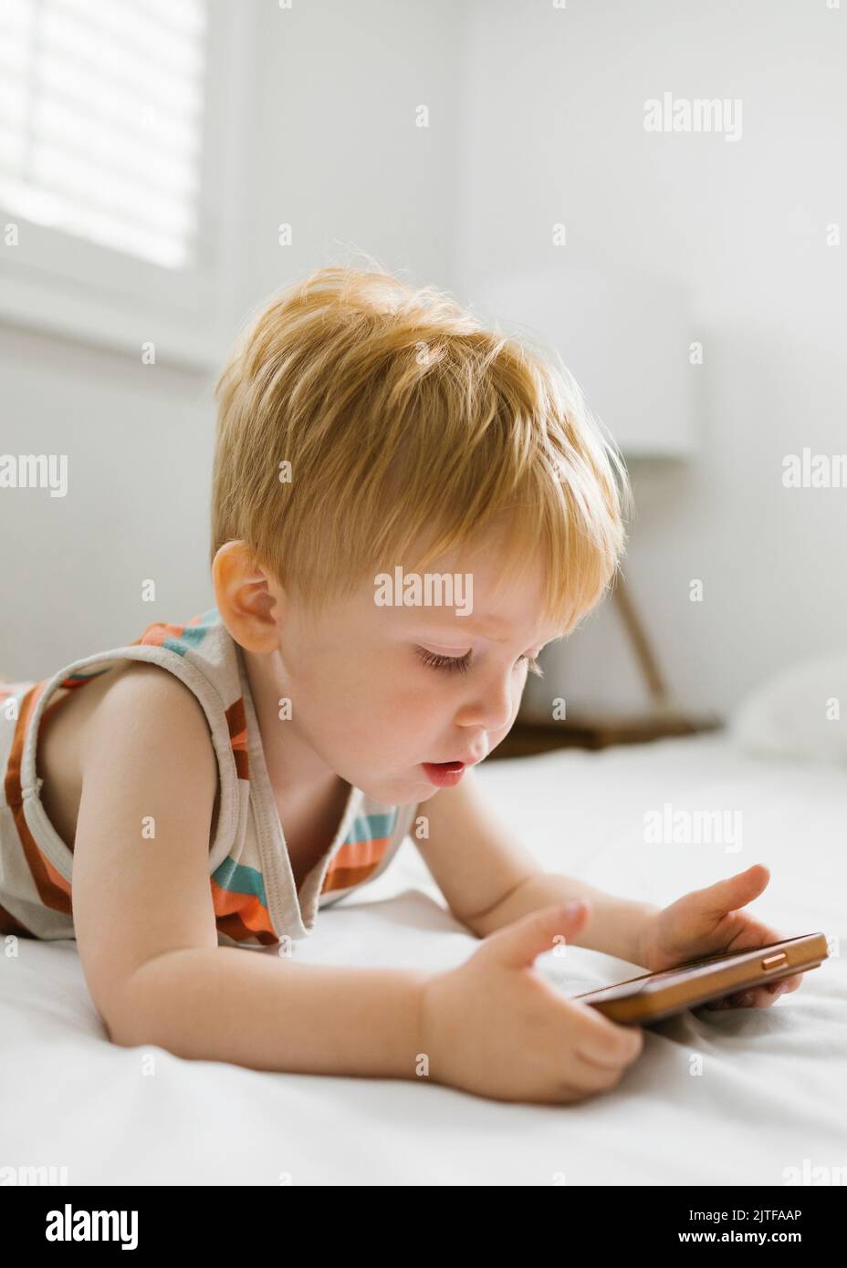 Boy (2-3) using smart phone Stock Photo