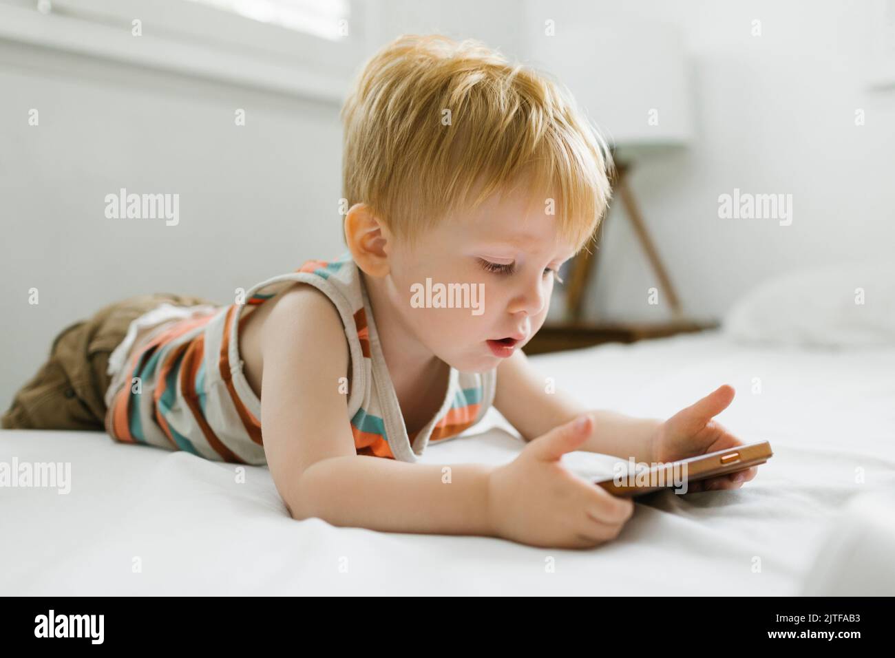 Boy (2-3) using smart phone Stock Photo