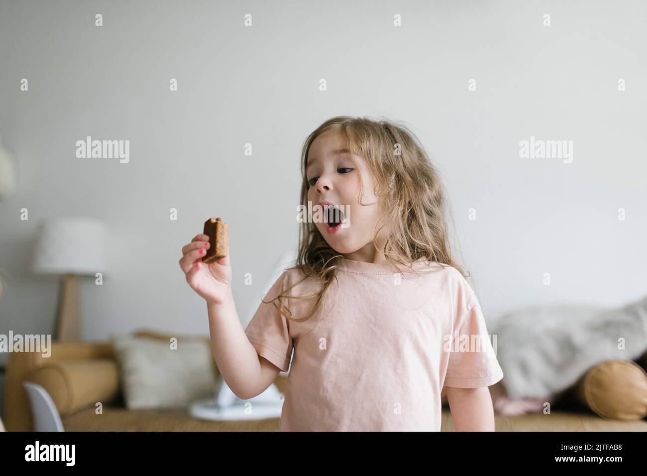Girl (2-3) eating snack Stock Photo