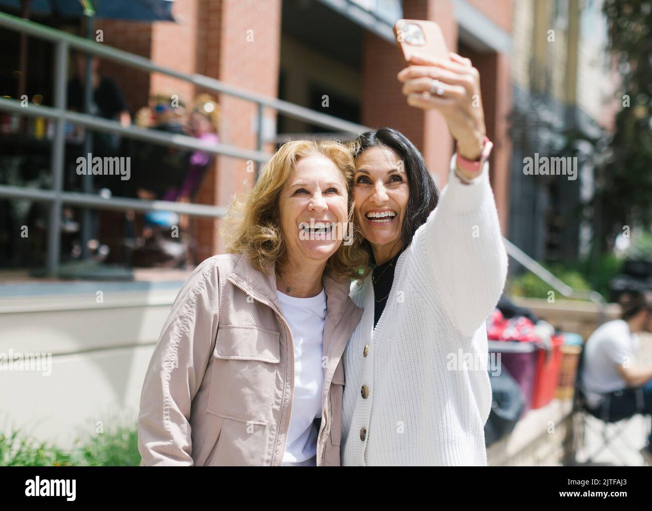 Smiling female friends taking selfie Stock Photo