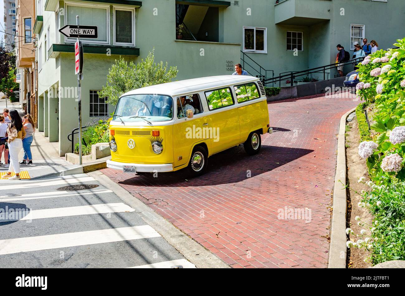 A yellow VW Camper Van with a white roof in immaculate condition on Lombard Street in San Francisco, California, USA Stock Photo