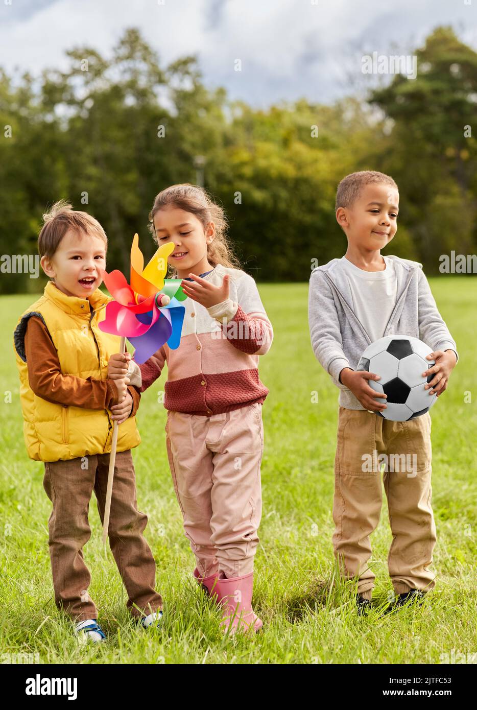 happy kids with pinwheel having fun at park Stock Photo - Alamy