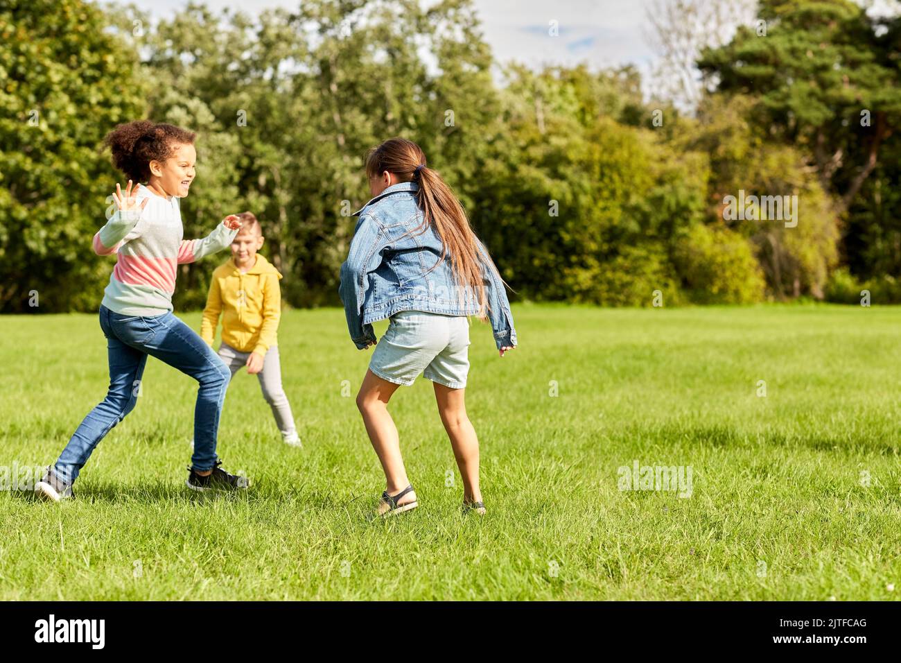 happy children playing and running at park Stock Photo - Alamy