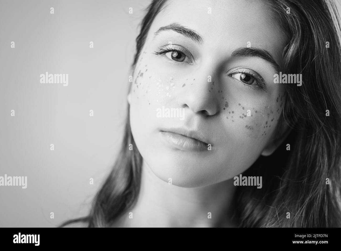 young woman beauty fashion glitter freckles makeup Stock Photo